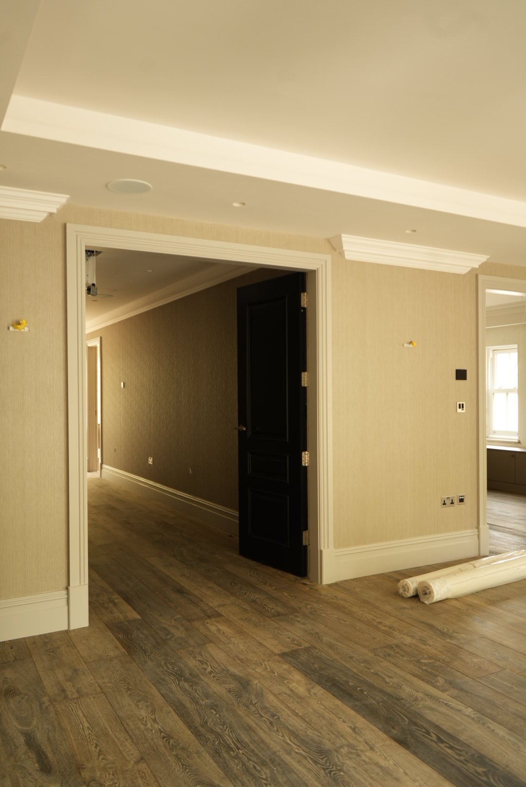 Wide-plank oak and dark-stained doors