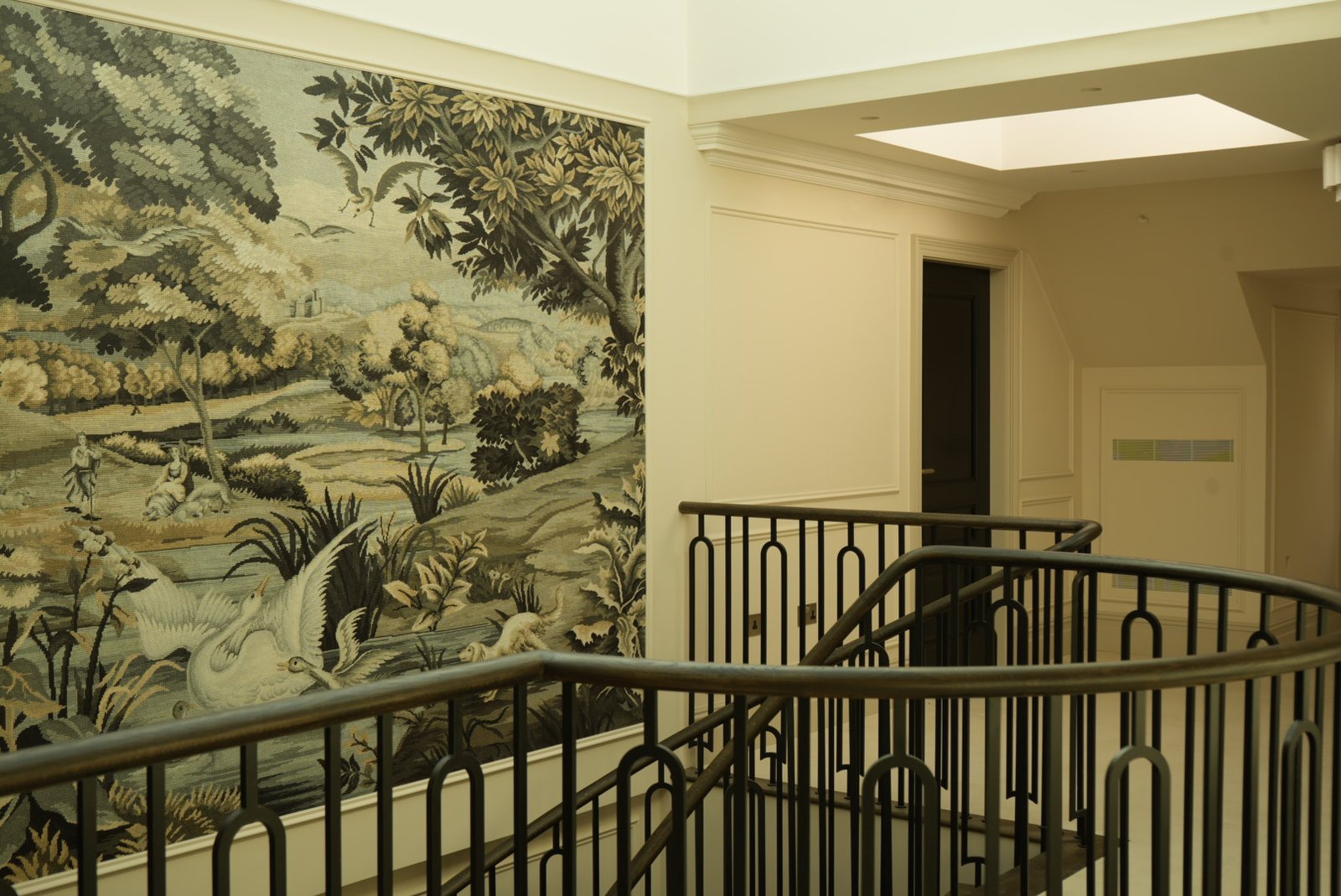 The mural landing at Bishops Avenue under the roof light, seen past the bronze balustrade