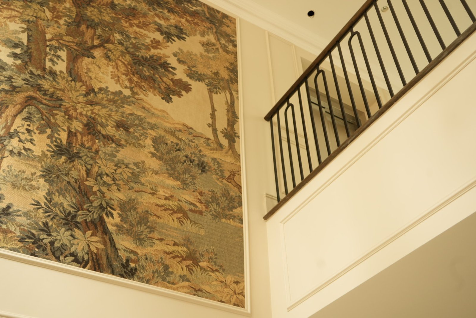 A second painted scene beside the stair