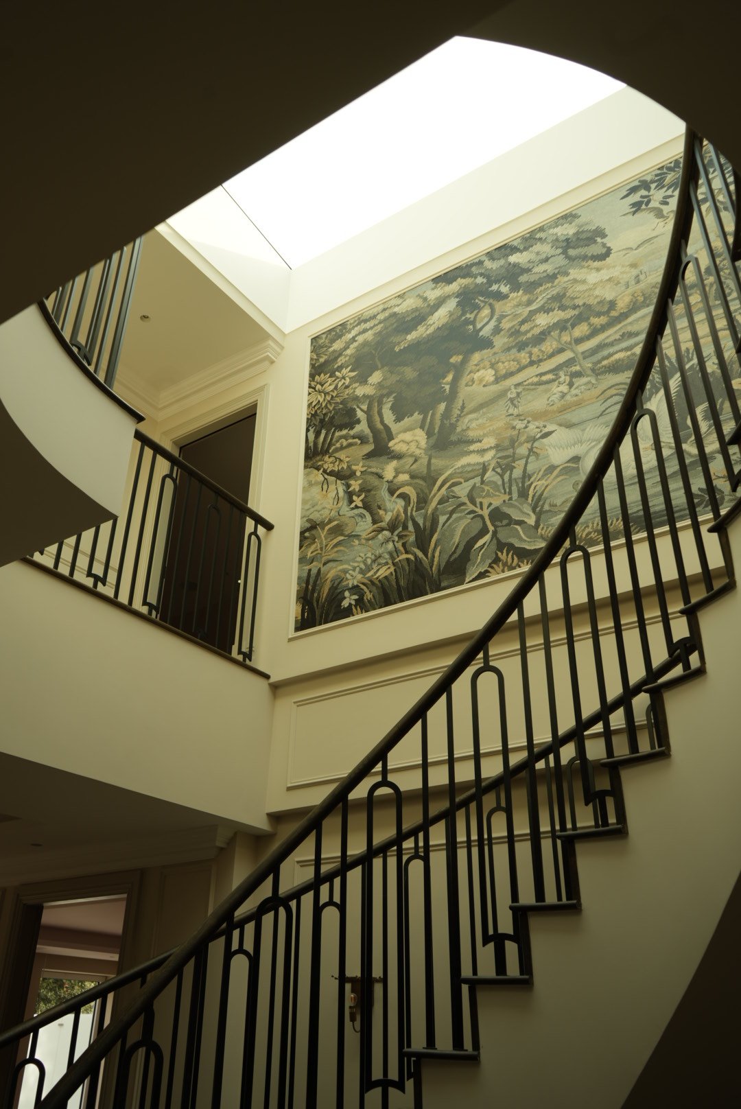 The mural glimpsed past the final flight
