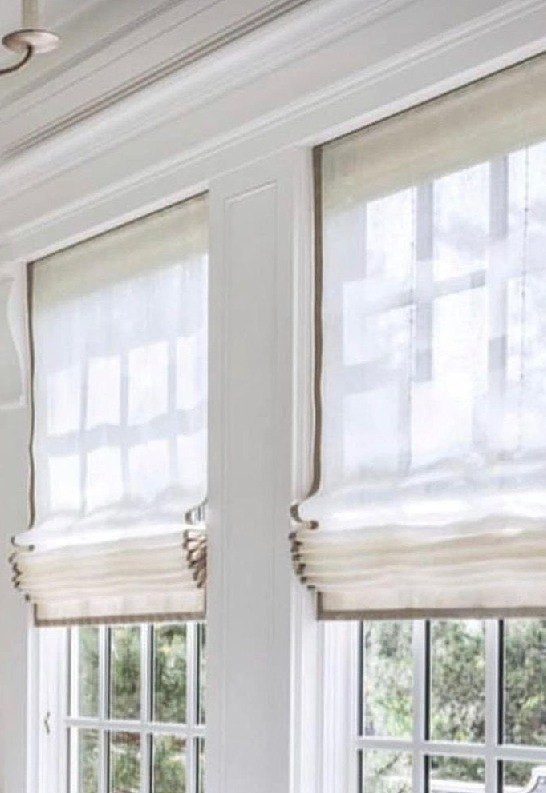 Sheer roman blinds on paired sash windows