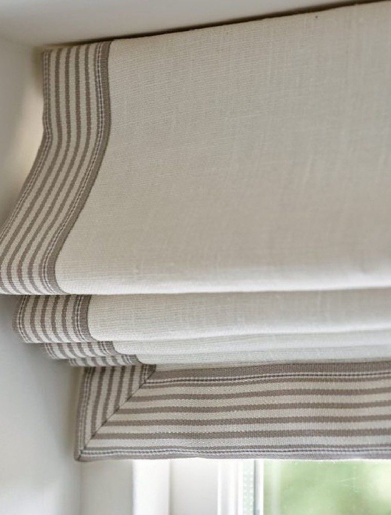 A roman blind with a striped border