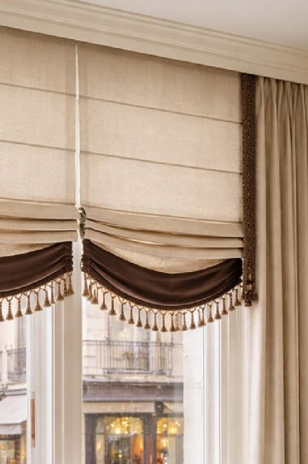 A swagged linen blind with a tasselled edge