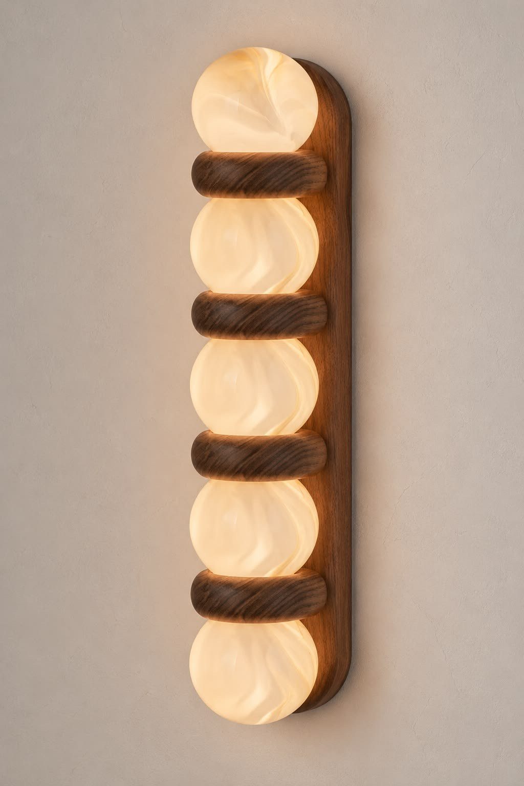 An alabaster and walnut wall light