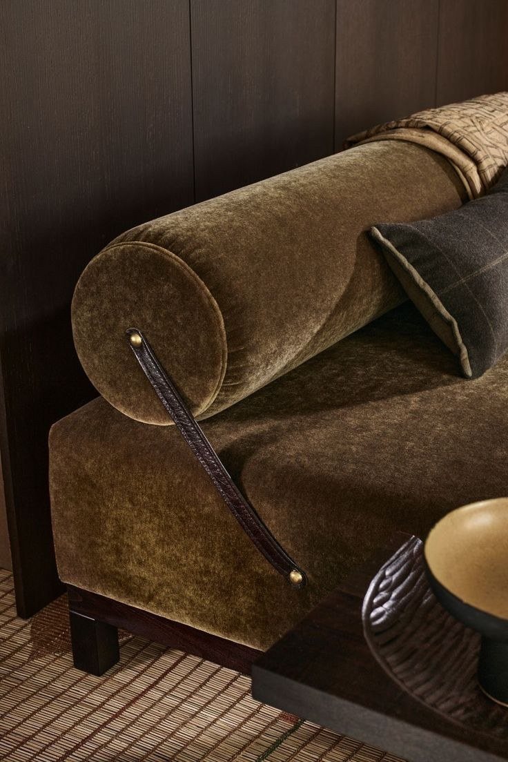 A mohair bolster with a leather strap