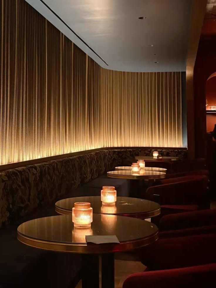 Uplit pleated drapery and candlelit tables