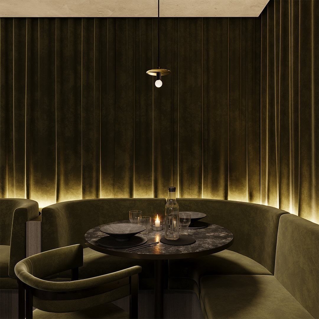 A banquette wrapped in olive velvet