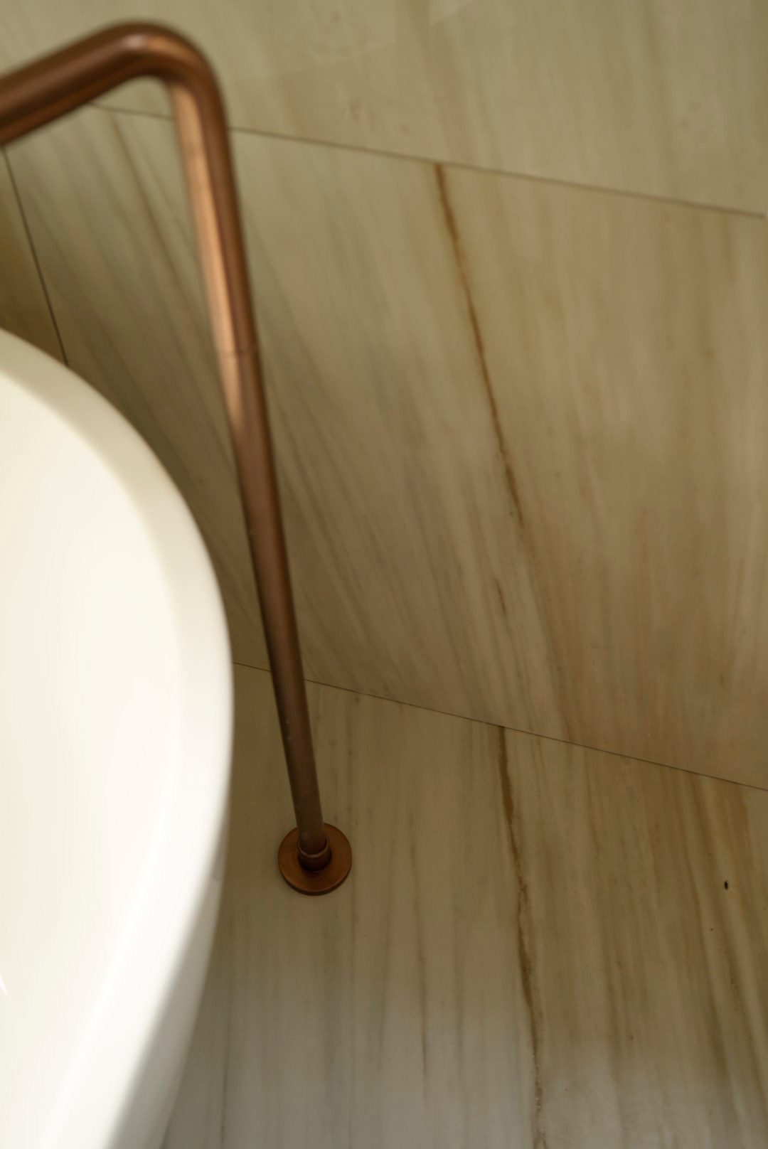 Bronze bath filler against stone